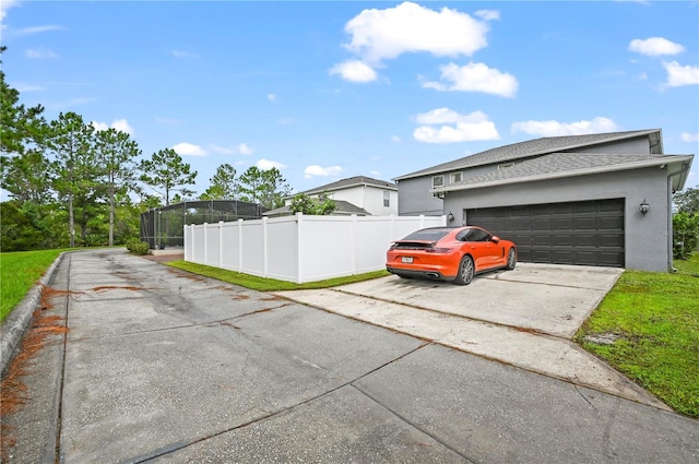 view of side of home featuring a garage and a lanai