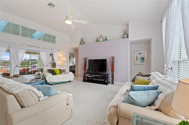 living room with ceiling fan and high vaulted ceiling