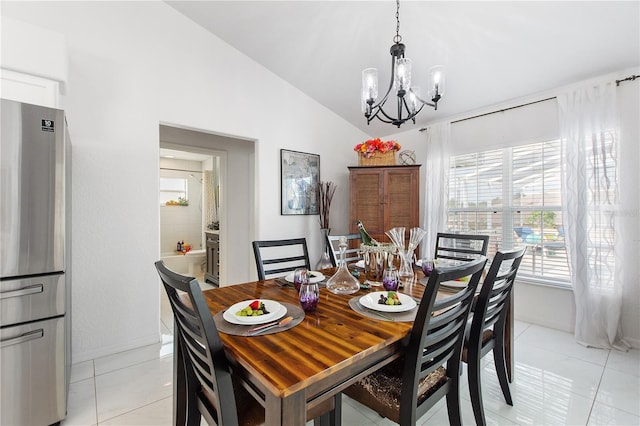 dining area with light tile patterned floors, vaulted ceiling, and a chandelier