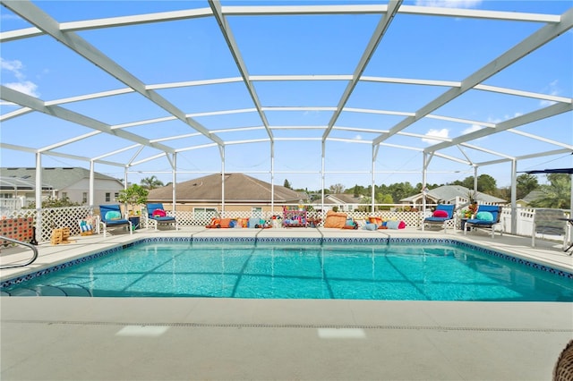 view of swimming pool featuring a lanai and a patio