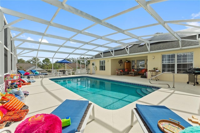 view of pool with a lanai and a patio