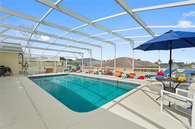 view of pool featuring a patio, a mountain view, and glass enclosure