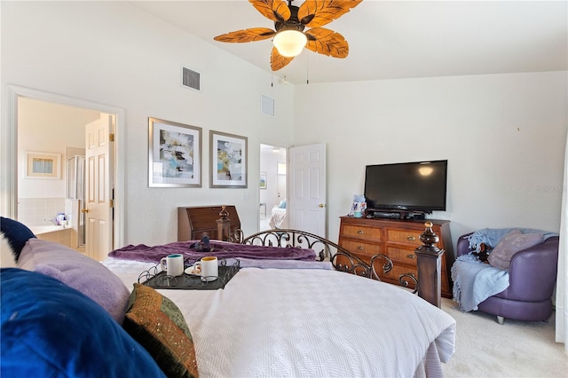 carpeted bedroom featuring connected bathroom and high vaulted ceiling