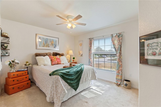 bedroom with light colored carpet and ceiling fan