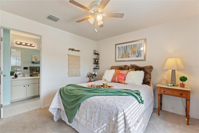 bedroom with connected bathroom, sink, light colored carpet, and ceiling fan