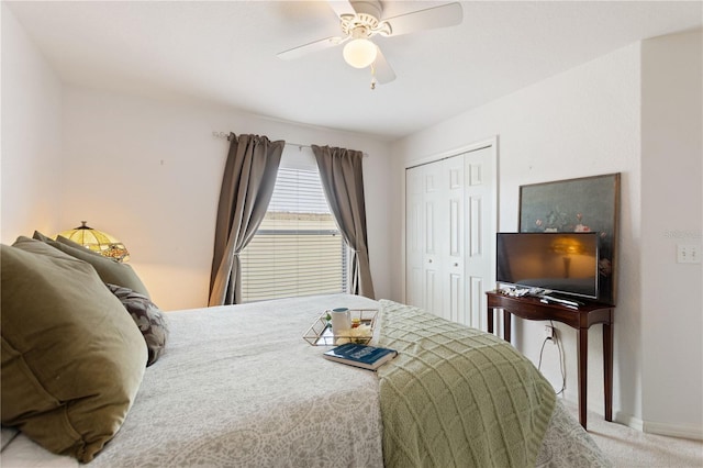 carpeted bedroom with ceiling fan and a closet