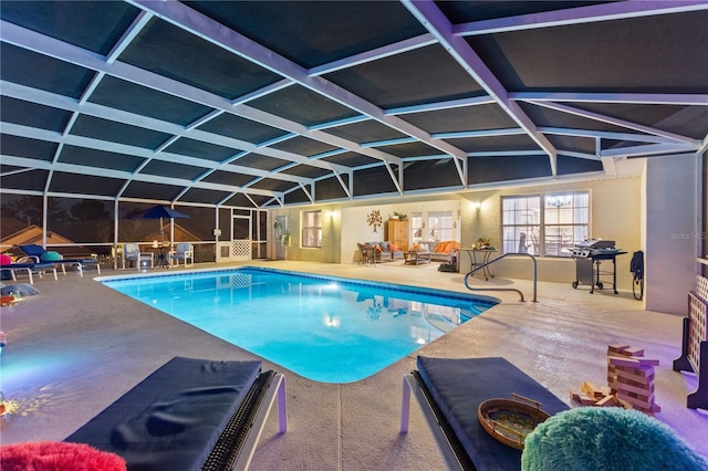 view of swimming pool featuring a lanai and a patio