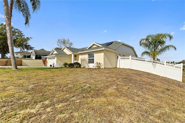 single story home with a garage and a front yard