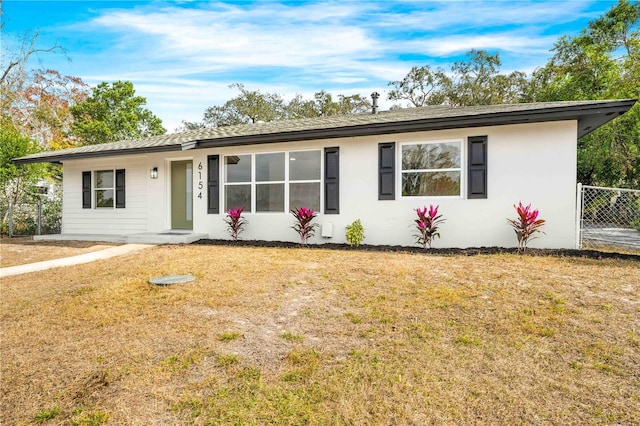 ranch-style house with a front lawn