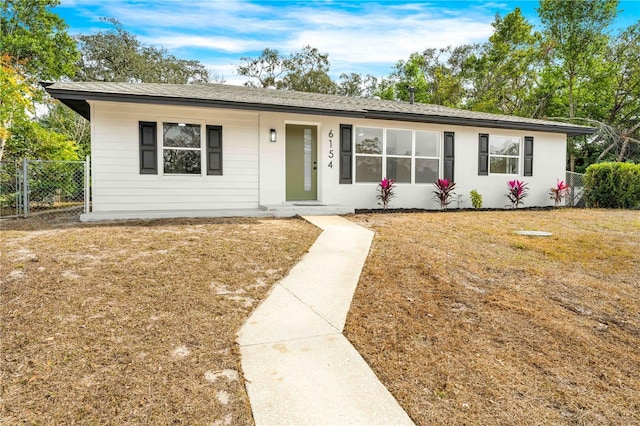 ranch-style home featuring a front yard