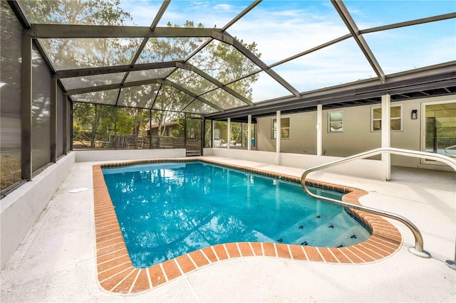 view of swimming pool with a patio and glass enclosure