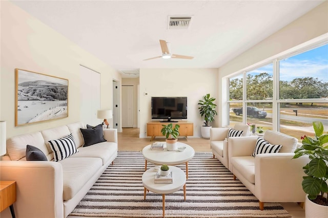 living room featuring ceiling fan and light wood-type flooring