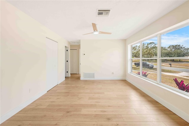 empty room featuring ceiling fan and light wood-type flooring