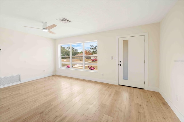 empty room featuring ceiling fan and light hardwood / wood-style floors