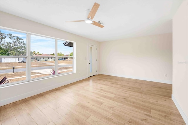 spare room with ceiling fan and light hardwood / wood-style floors