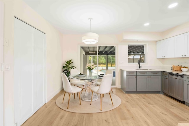 dining area featuring sink and light wood-type flooring