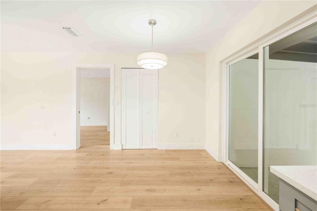 unfurnished dining area with light hardwood / wood-style floors