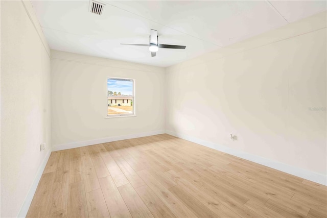 empty room with ceiling fan and light hardwood / wood-style flooring