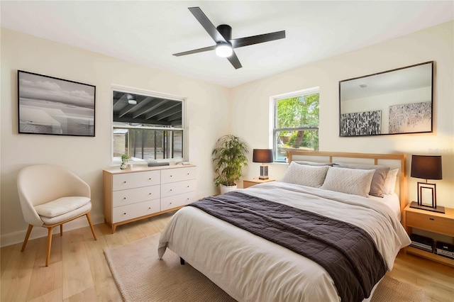 bedroom with ceiling fan and light wood-type flooring