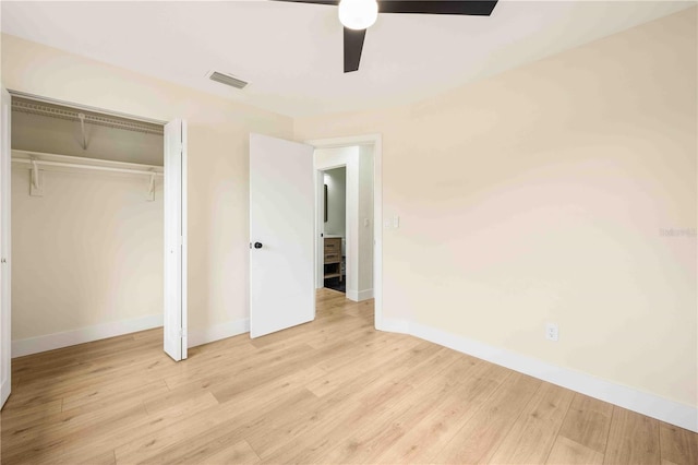 unfurnished bedroom featuring ceiling fan, a closet, and light wood-type flooring