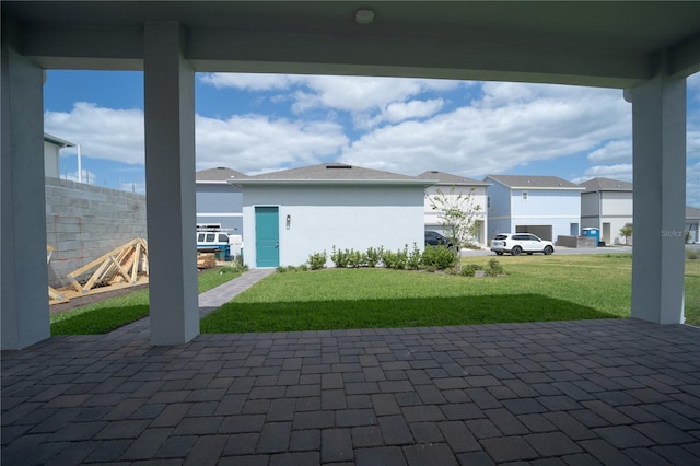 view of patio featuring fence and a residential view