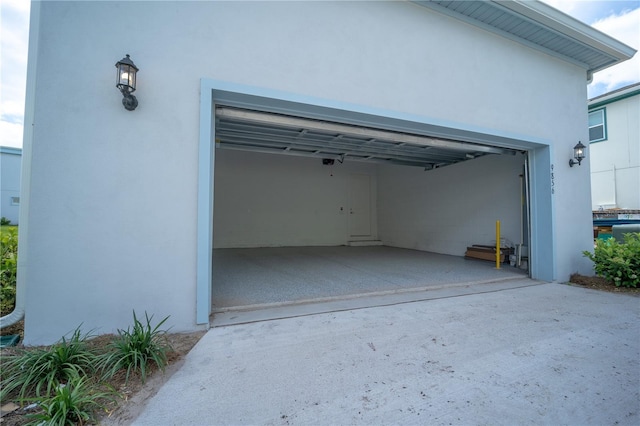 garage featuring concrete driveway