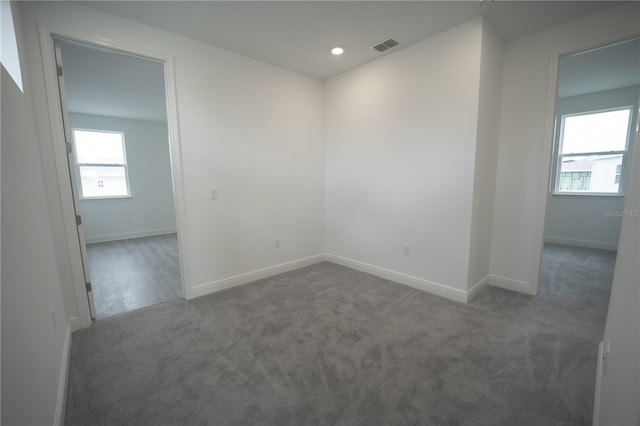 spare room with recessed lighting, visible vents, baseboards, and carpet floors