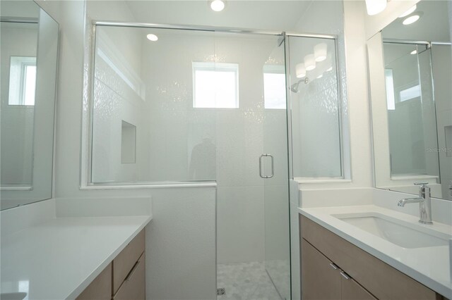 full bathroom with a shower stall and vanity