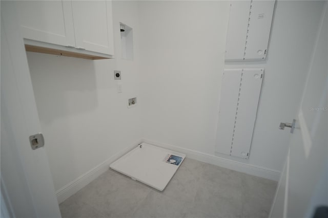 washroom with hookup for a washing machine, cabinet space, baseboards, and hookup for an electric dryer