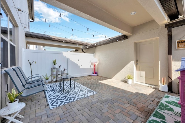 view of patio featuring fence