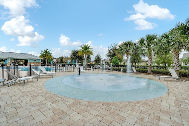 view of swimming pool with pool water feature