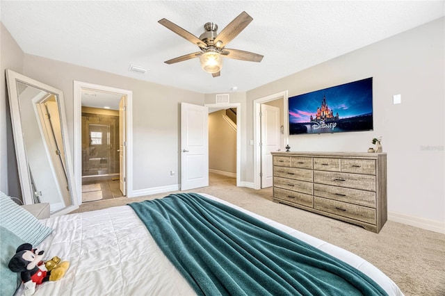 bedroom featuring baseboards, light carpet, and a textured ceiling