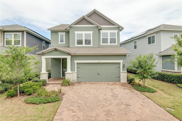 view of front of property with a garage and a front yard