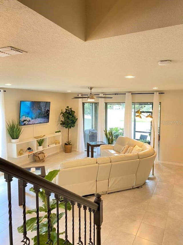 tiled living room with a textured ceiling