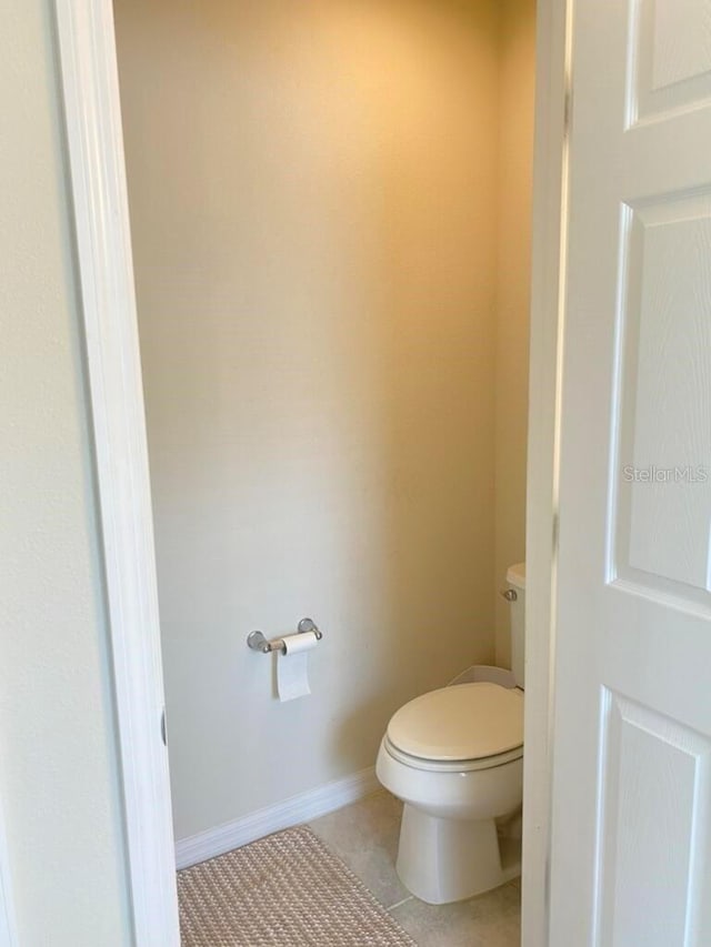 bathroom with tile patterned floors and toilet