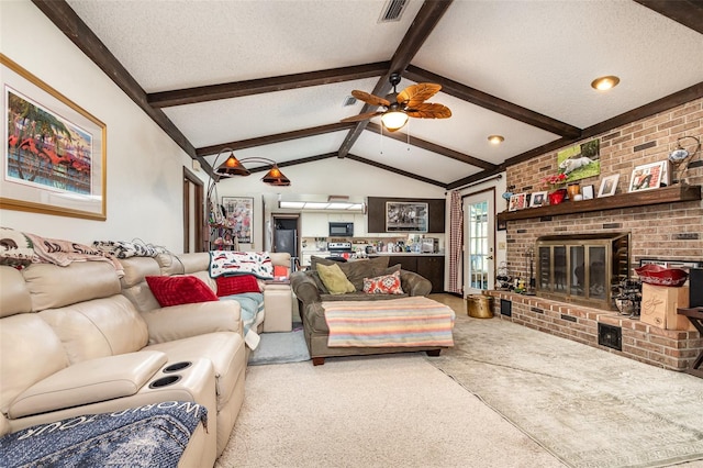 carpeted living room with lofted ceiling with beams, ceiling fan, a brick fireplace, and a textured ceiling