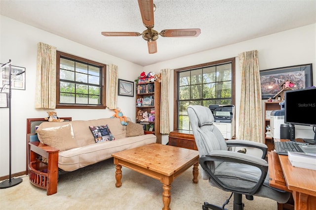 office space with a textured ceiling, ceiling fan, and carpet flooring