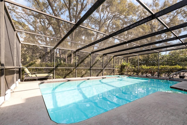 view of swimming pool with a lanai and a patio