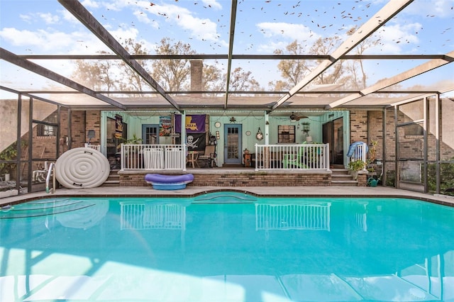 view of swimming pool featuring a patio and glass enclosure