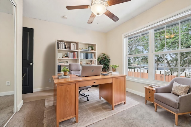 office with light colored carpet and ceiling fan