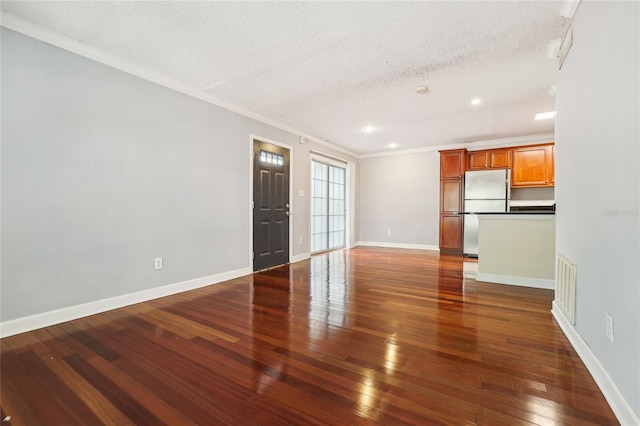 interior space with dark hardwood / wood-style flooring, crown molding, and a textured ceiling