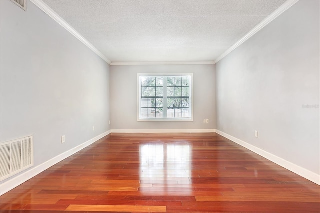 empty room with hardwood / wood-style flooring, crown molding, and a textured ceiling