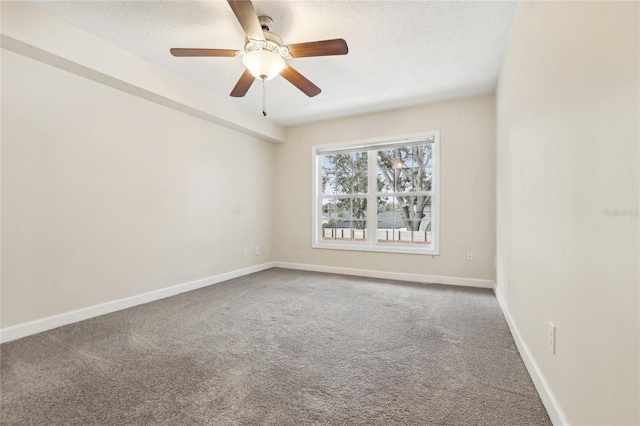 unfurnished room with ceiling fan, carpet flooring, and a textured ceiling