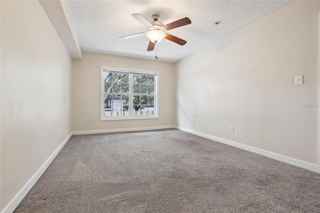 empty room with ceiling fan, carpet, and a textured ceiling