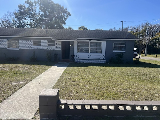 ranch-style home with a front lawn