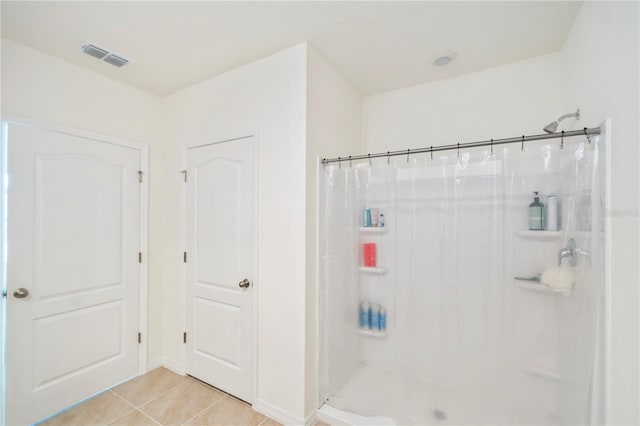 bathroom featuring visible vents, tile patterned flooring, and a shower with curtain