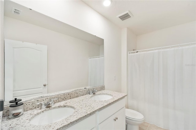 full bath featuring toilet, a sink, and visible vents