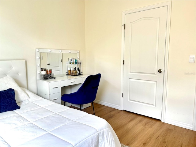 bedroom featuring baseboards and wood finished floors