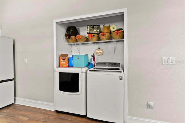 laundry area featuring dark hardwood / wood-style flooring and washing machine and clothes dryer