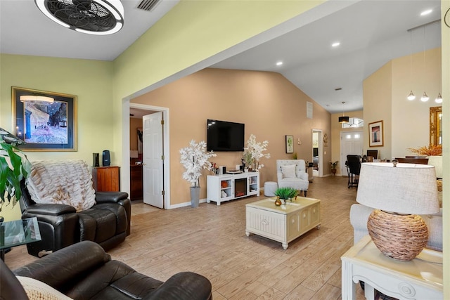 living room with vaulted ceiling and light hardwood / wood-style floors